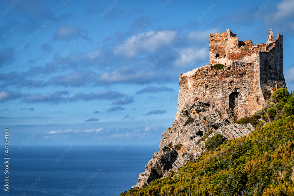 The ancient Torre Vecchia tower overlooking the sea, Gorgona island, Livorno, Italy, on a sunny day