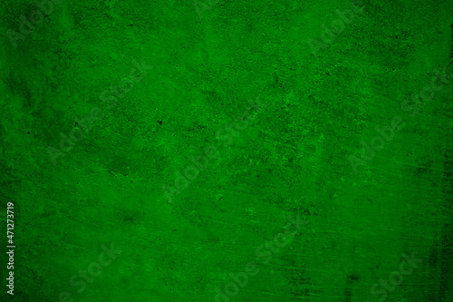 Green grunge background. Concrete wall. Toned cement surface texture. Rough background with copy space for design.