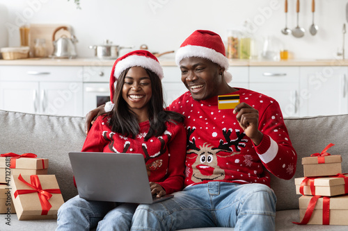 Happy black family shopping online  buying gifts  xmas sales concept