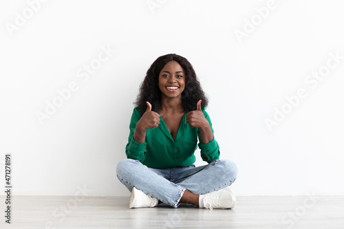 Happy african american young woman showing thumb ups