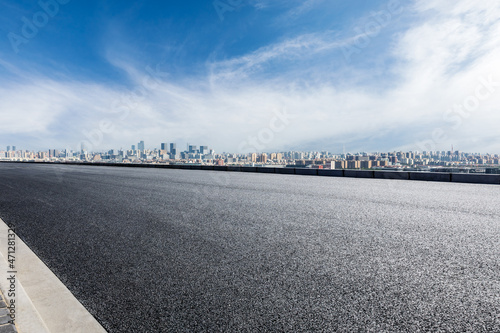 Photography Asphalt road and modern city commercial buildings with skyline under blue sky