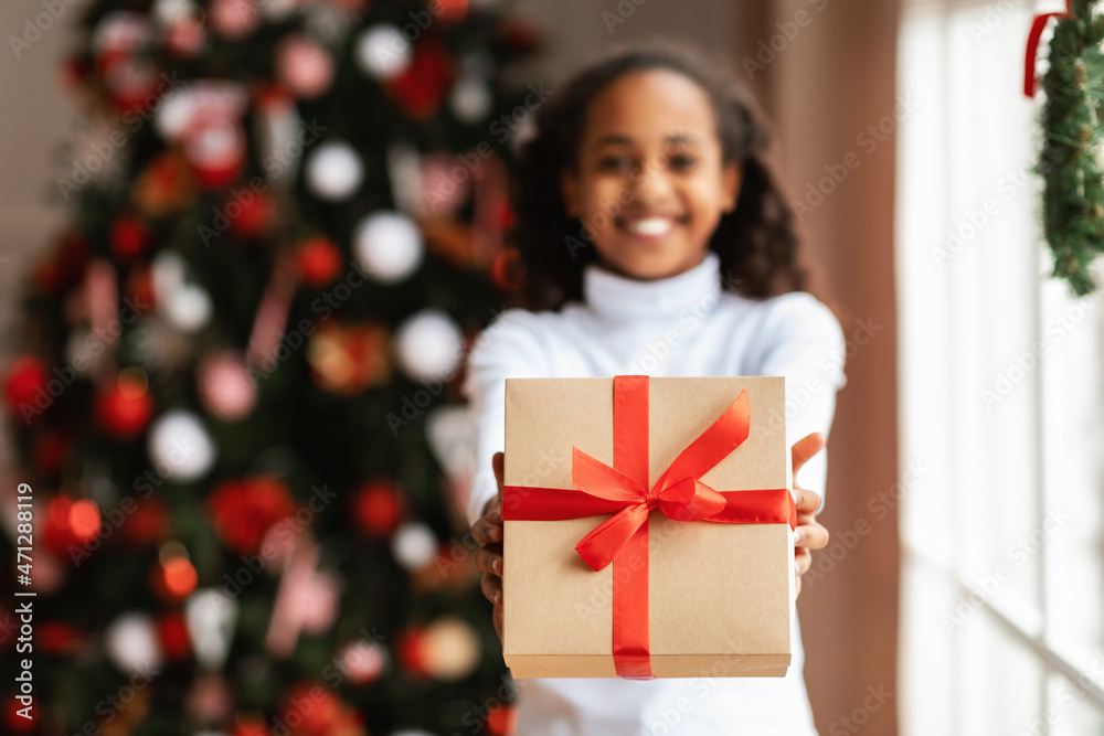 Black Girl Holding And Giving Christmas Present At Home Black Girl Holding And Giving Christmas Present At Home