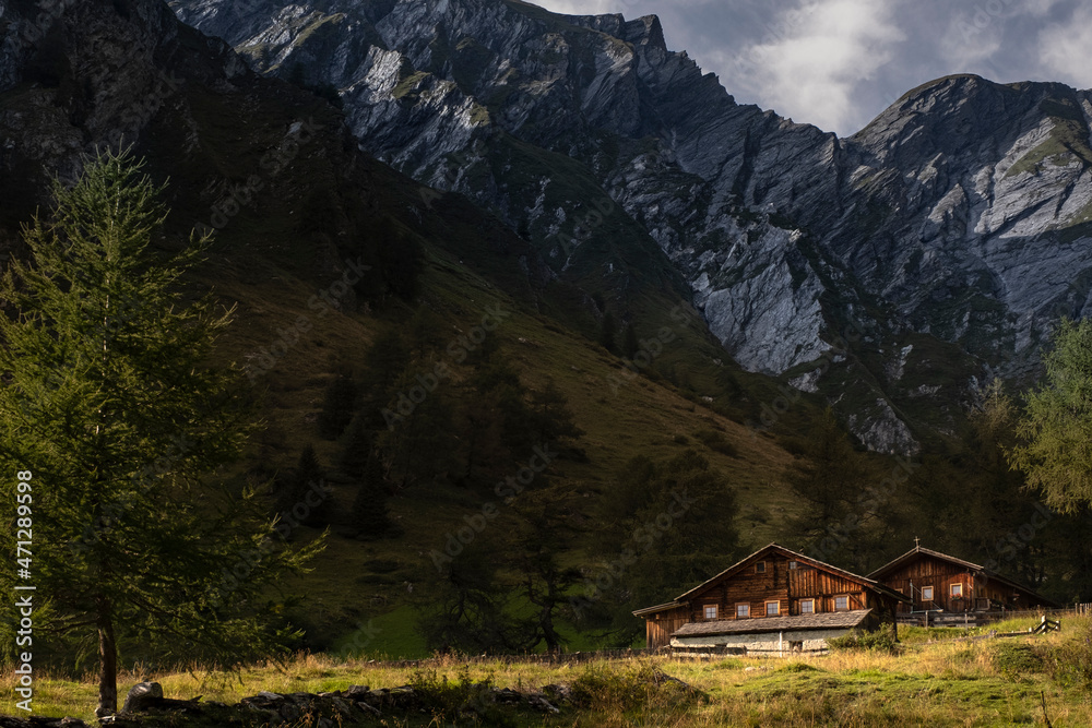 Cabin in the Mountains with rock walls in the background Cabin in the Mountains with rock walls in the background