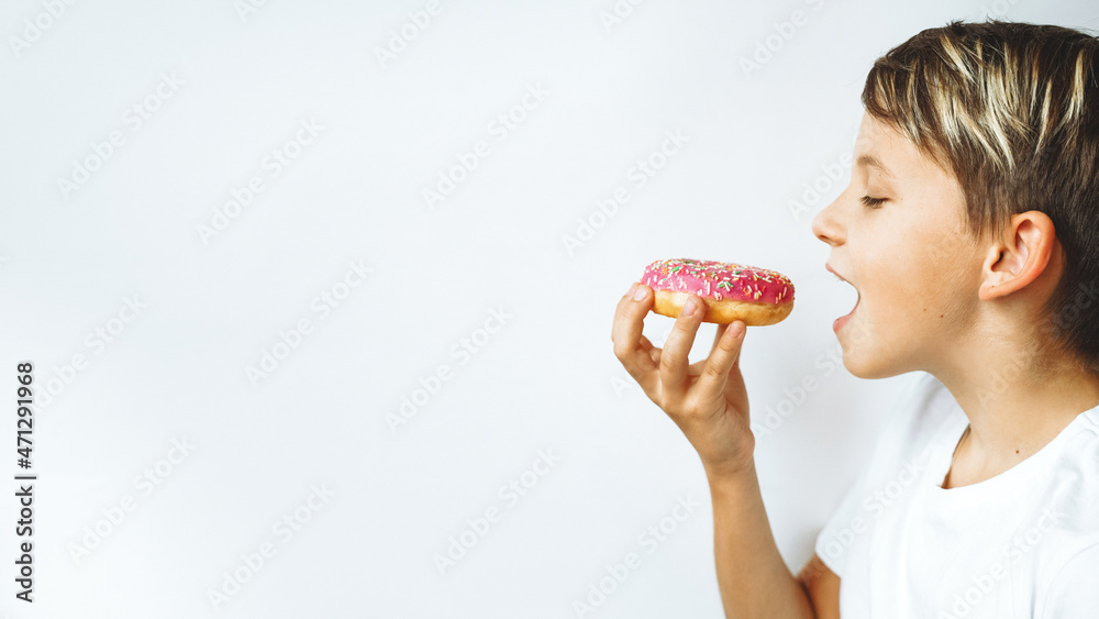 A child, a boy eating a donut. Banner, white background. A child, a boy eating a donut. Banner, white background.