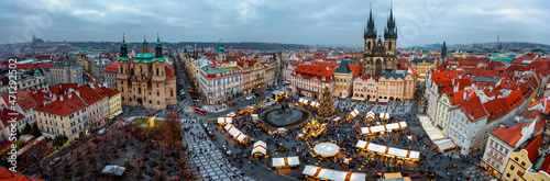 Elevated, panoramic view of the skyline of Prague during a cold winter day with the traditional christmas market on the old town square and festive decorations throghout the city