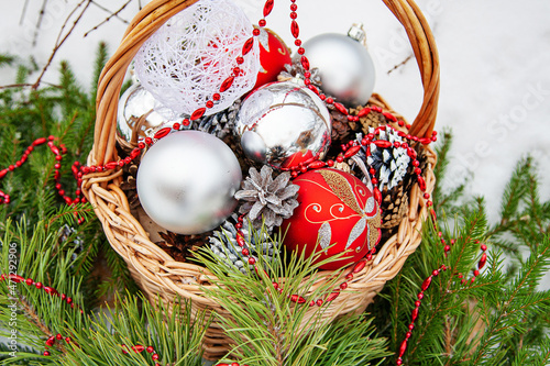 basket with Christmas toys and coniferous branches
