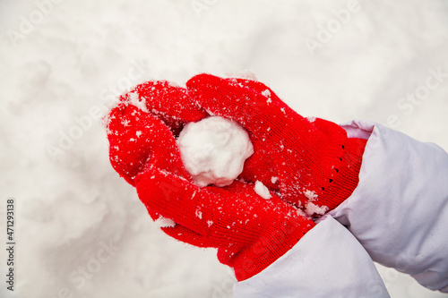 snow on red mittens
