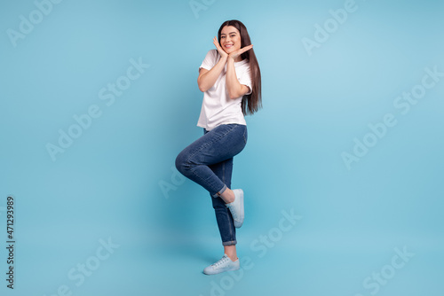 Full body profile side photo of young charming lady arms touch chin wear casual outfit isolated over blue color background
