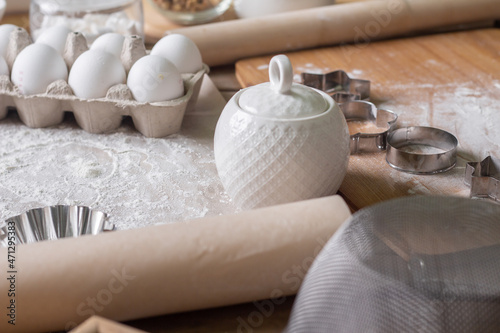 A composition of ingredients for homemade pastries on a wooden table.