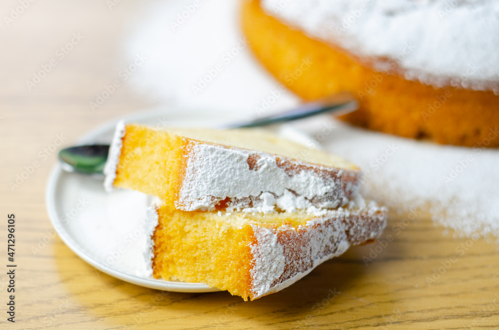 Portion of Madeira ring loaf cake served on a small plate Portion of Madeira ring loaf cake served on a small plate