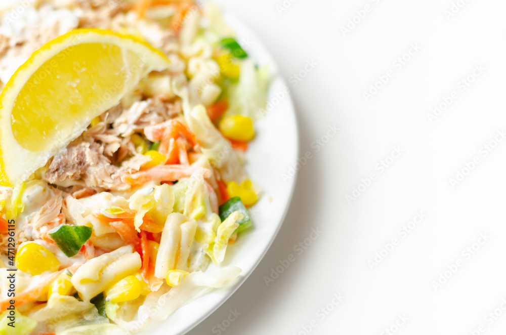 Cavatelli pasta with tuna and iceberg lettuce, carrots, sweet corn and cucumber in a sauce mayonnaise Cavatelli pasta with tuna and iceberg lettuce, carrots, sweet corn and cucumber in a sauce mayonnaise