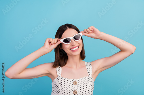 Photo of charming pretty lady carefree summer holiday wear sunglass dotted overall isolated blue color background