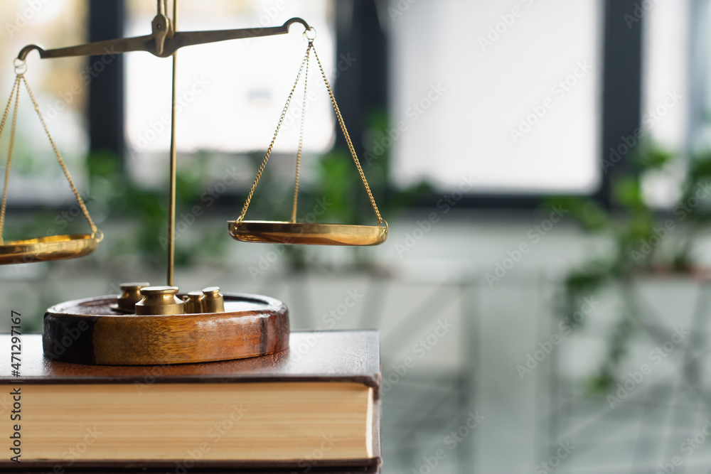 close up view of bronze justice scales on codex book in office, anti-corruption concept close up view of bronze justice scales on codex book in office, anti-corruption concept
