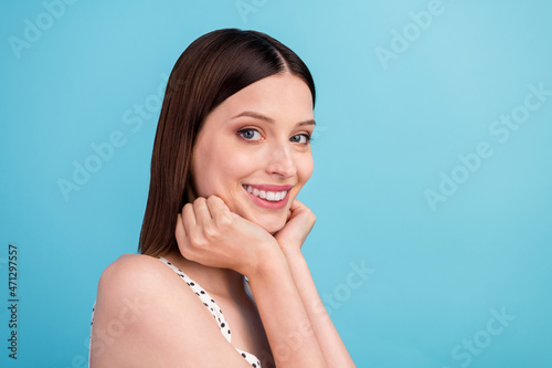 Photo of adorable cute sweet lovely lady hands cheeks beaming smile wear dotted overall isolated blue color background