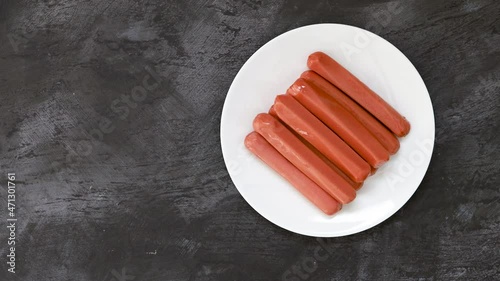 Serving a Plate of Raw Hotdogs with room for Copy photo