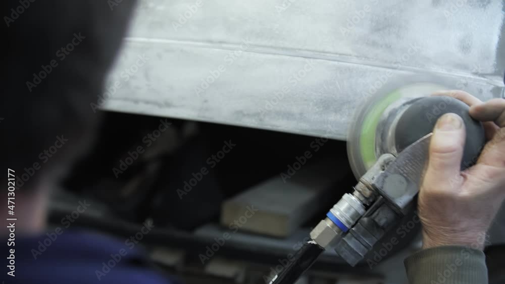 polishing of the damaged car door with a grinder polishing of the damaged car door with a grinder