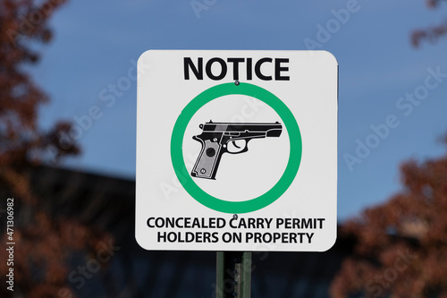 NOTICE - CONCEALED CARRY PERMIT HOLDERS ON PROPERTY sign. CCW or carrying a concealed weapon notification upon entering property. photo
