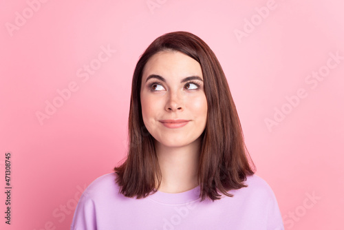 Photo of young charming girl wondered look empty space minded thoughtful isolated over pink color background