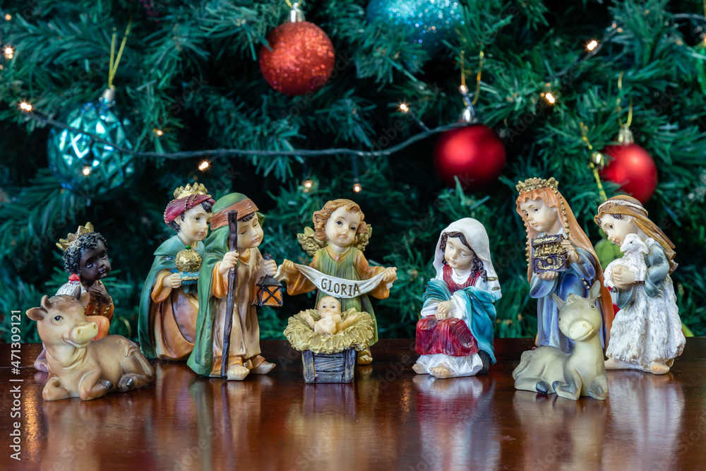 Traditional Christmas nativity scene with Christmas tree and flashing lights in the background.Christmas nativity scene in fine detail, Christmas background.