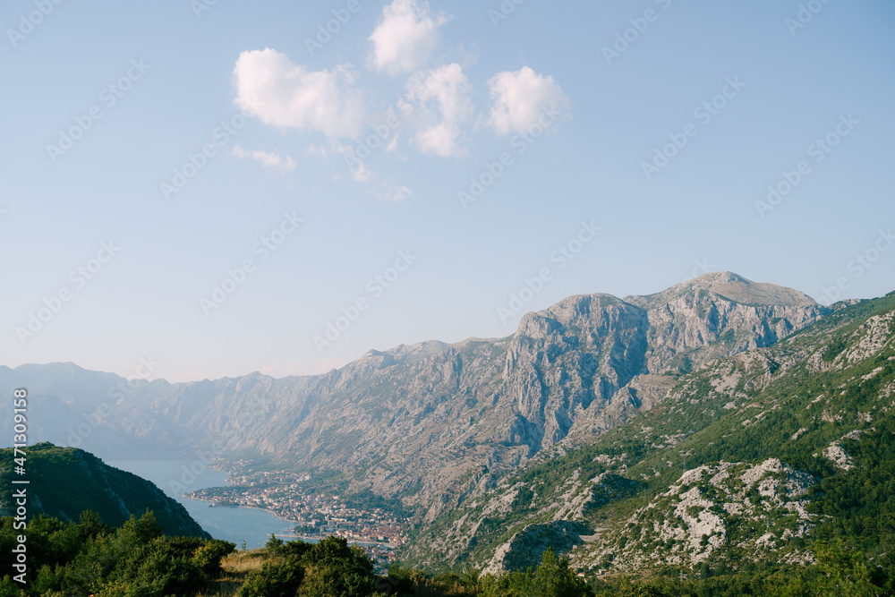 Kotor Bay surrounded by a ring of mountains in the sun. Montenegro