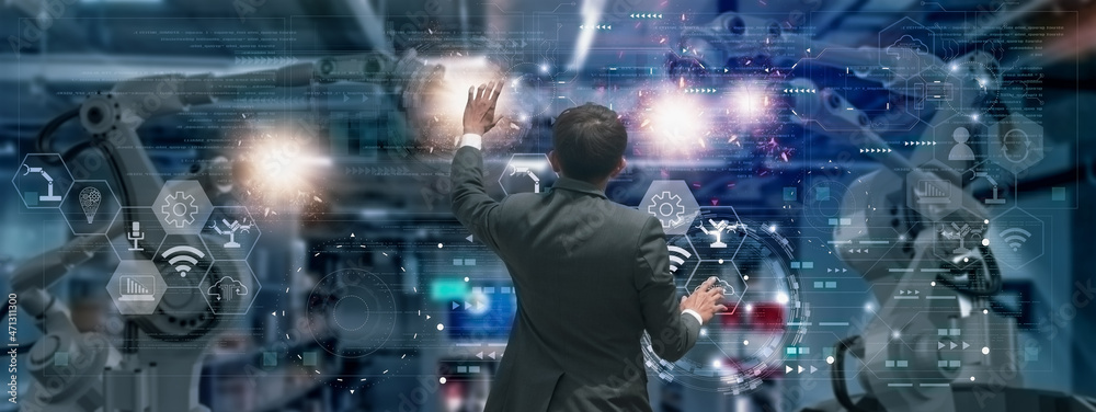 Industrial engineer in factory,hand control automated robot arm machine ...