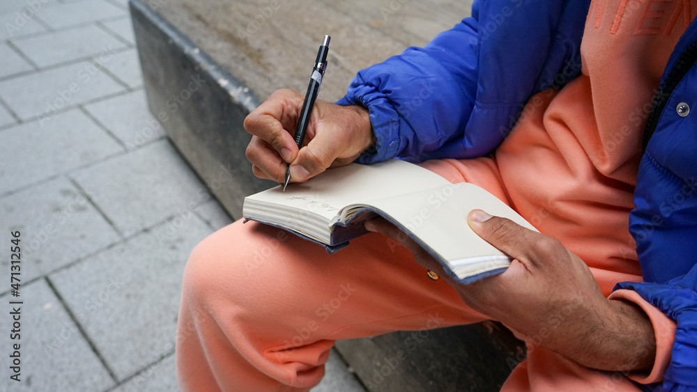 Fototapeta premium Close up of man writing in diary