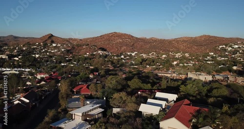 4K aerial Windhoek capital residential central hilly district bright sunset drone video with upmarket houses and old white walls German mansion on top of hill in Khomas Region, central Namibia photo