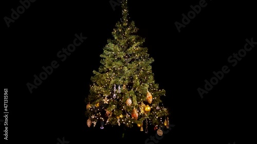 Decorating a Christmas tree for Christmas, stop motion. Beautiful gold decorations for winter holidays.