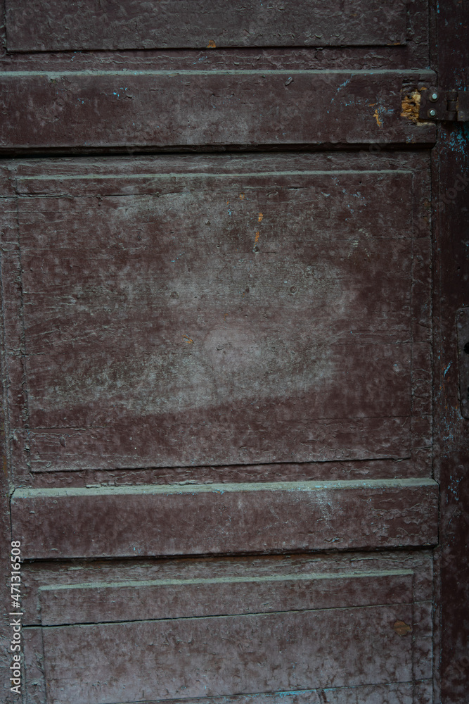 Old wooden door with remnants of dark peeling paint Old wooden door with remnants of dark peeling paint