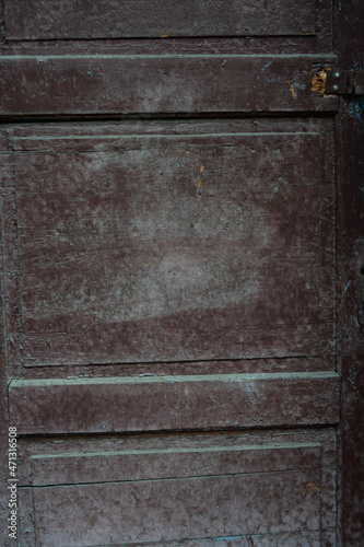 Old wooden door with remnants of dark peeling paint