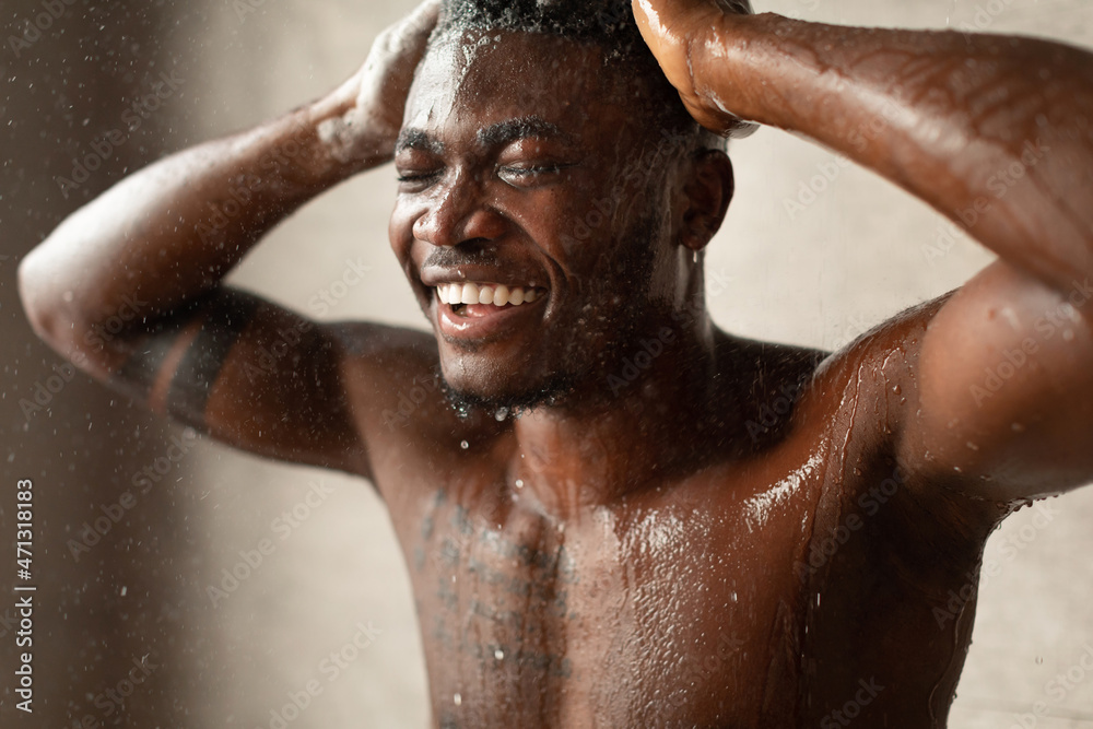 Black Male Taking Shower Washing Head With Eyes Closed Indoor