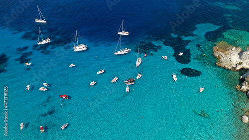 Aerial photo of luxury sail boat anchored in tropical Caribbean rocky turquoise colour seascape