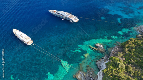 Aerial photo of luxury sail boat anchored in tropical Caribbean rocky turquoise colour seascape © aerial-drone