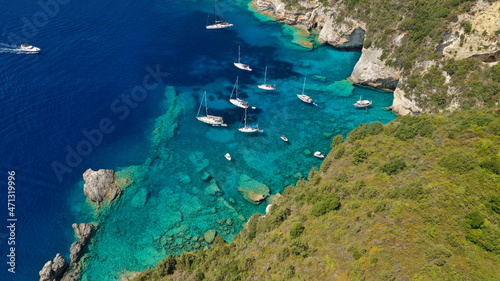 Aerial drone photo of paradise bay an caves of blue lagoon in beautiful island of Paxos visited by yachts and sail boats, Ionian, Greece