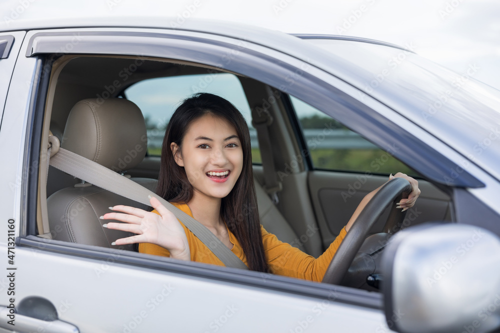 Wow. Young beautiful asian women getting new car. she very happy and excited. she sit and touching every detail of car. Smiling female driving vehicle on the road