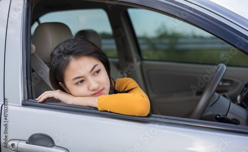 Young asian woman has broken down car on the road she feeling serious and stressed.Look for someone help. Call Emergency assistance or insurance service. © Chanakon