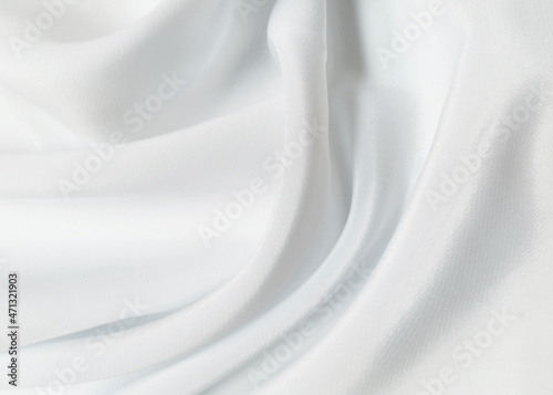 White crumpled or wavy fabric texture background. Abstract linen cloth soft waves. Creases of satin, silk, and cotton. Smooth elegant silk or atlas luxury cloth texture. Bedding Sheets or blanket.