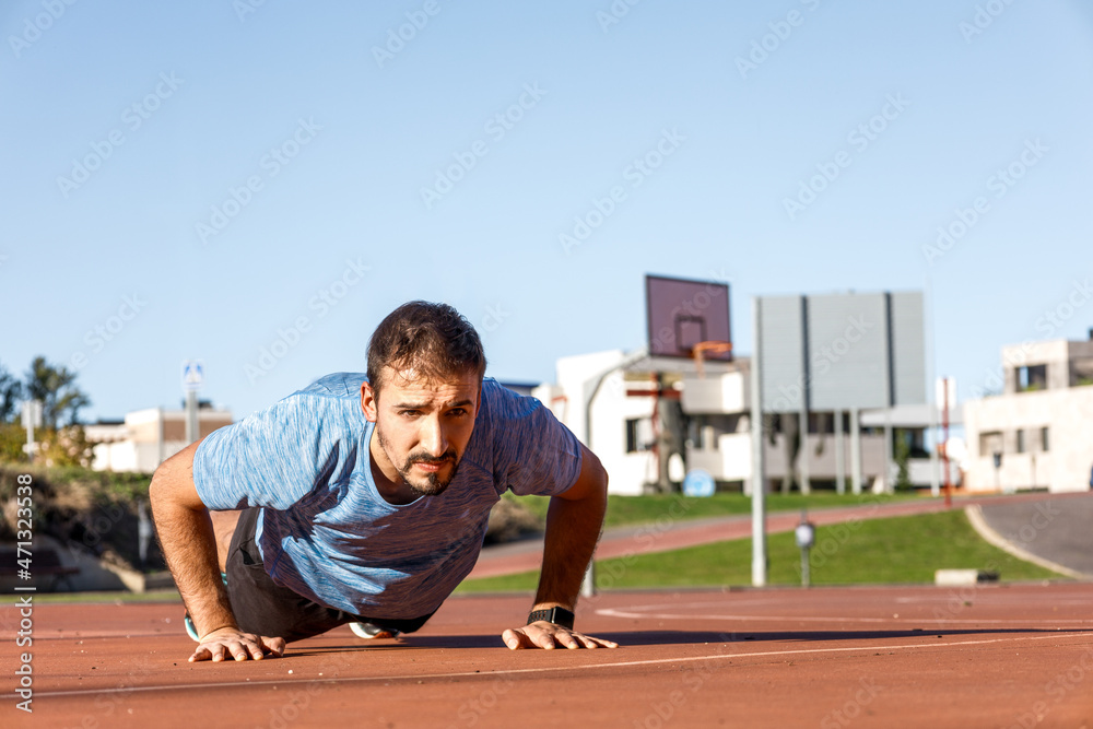 full view of millennial caucasian man doing push-ups in basket court, copy  space Stock Photo | Adobe Stock