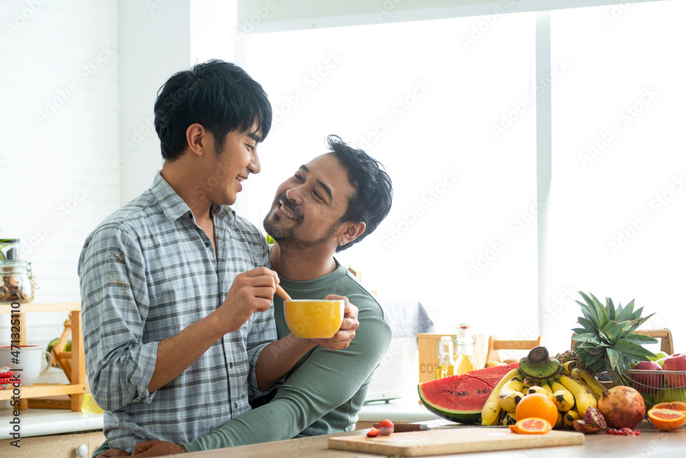Romantic Lgbtq couple having a sweet time together and holding soup bowl, spending time togetherness looking to each other Romantic Lgbtq couple having a sweet time together and holding soup bowl, spending time togetherness looking to each other
