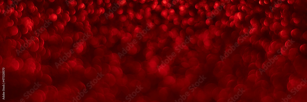 Red sparkling glitter bokeh background, christmas texture. Holiday lights. Abstract defocused header. Wide screen wallpaper. Panoramic web banner with copy space for design