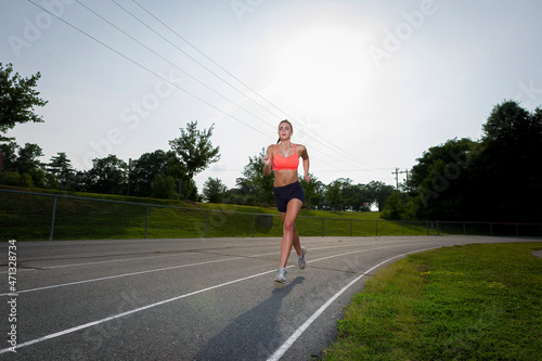 Young Athlete Exercising On A Local Track