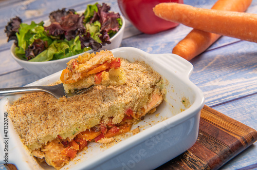 Salmon Parmentier recipe with hazelnuts, young salad leaves. High quality photo photo