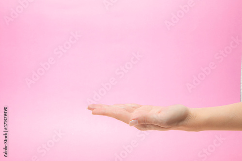 Woman s hand sign isolated on pink background

