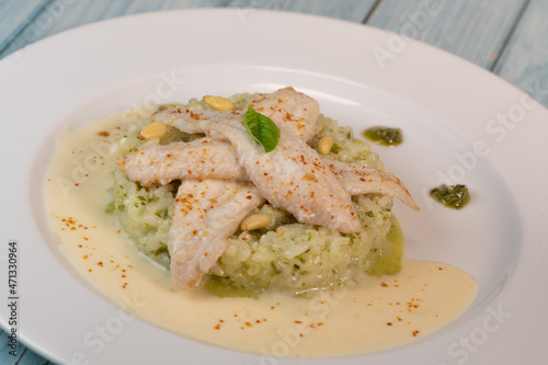 Baked sole fillet, risotto and pesto recipe. High quality photo