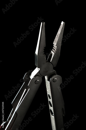 Multitool on black background 