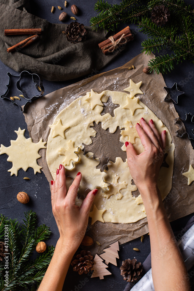 Christmas cooking and baking, female hands making cookies from dough