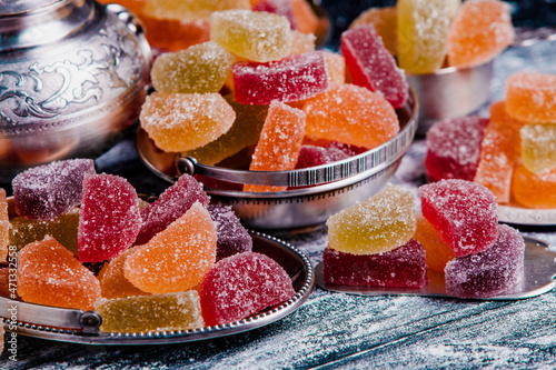 Dessert marmalade in the form of lemon and orange slices. The sweetness of jelly candy. photo