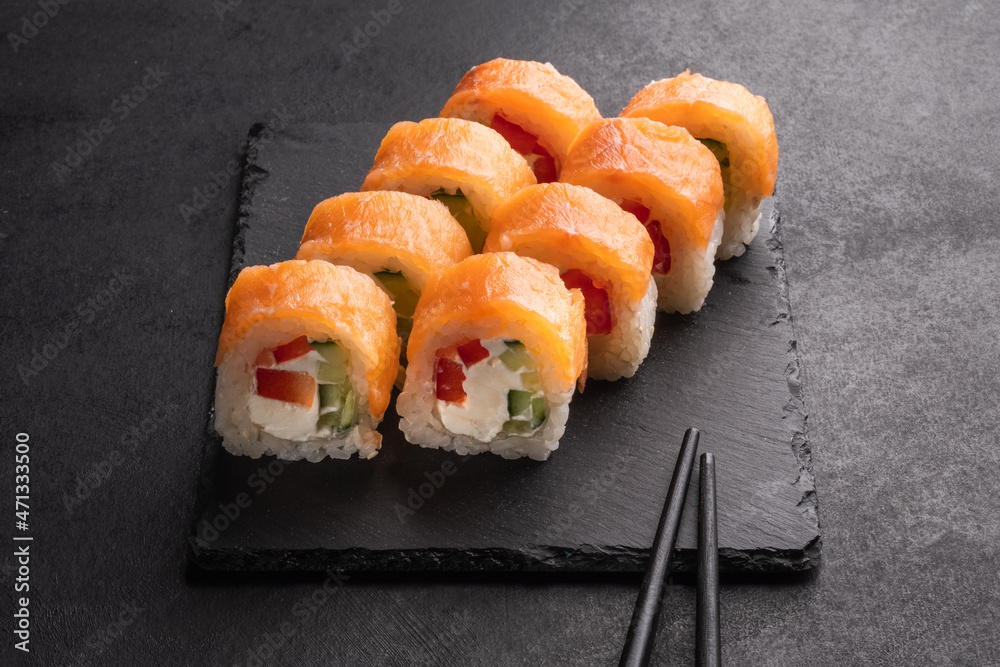 Philadelphia Sushi Rolls Set with Salmon and Cream Cheese. Japanese cuisine. Tasty food. Fish and rice. Philadelphia Sushi Rolls Set with Salmon and Cream Cheese. Japanese cuisine. Tasty food. Fish and rice.