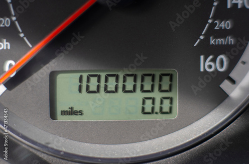 A car odometer with 100,000 miles  photo