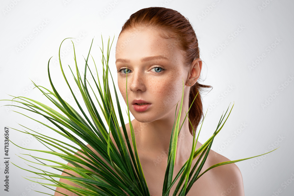 Fototapeta premium Headshot Of Young Lady Posing With Green Plant In Studio